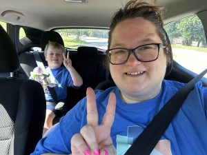 Sarah and her son in a car delivering groceries for CCC